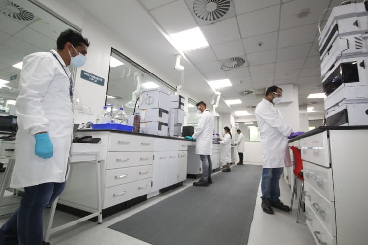 Scientists and lab technicians at Aarti Industries operating HPLC and analytical instruments in quality control laboratory