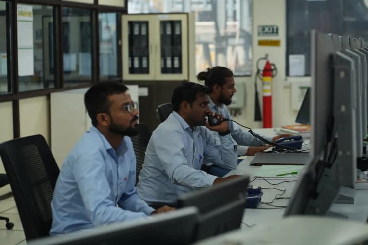 Team in PPE collaborating on plant operations inside Aarti Industries facility