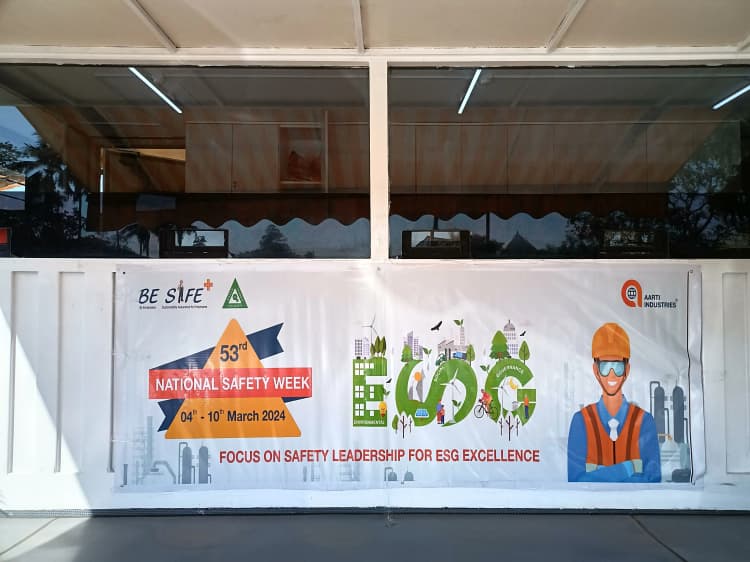 Employees in safety attire at Aarti Industries chemical manufacturing site